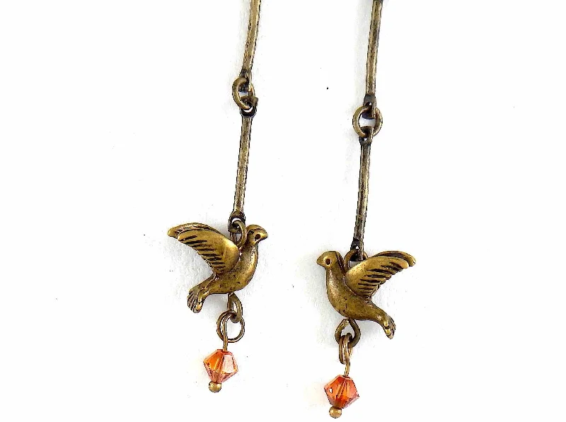 Long earrings with small brass flying birds and burnt orange Swarovski crystals, brass hooks