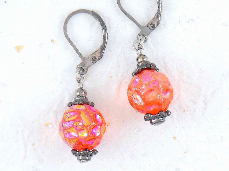 Short earrings with intense iridescent orange vintage glass raspberry beads, black nickel metal lever back hooks