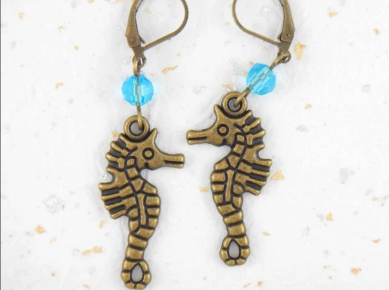 Long earrings with brass seahorses and turquoise Swarovski crystals, brass lever back hooks